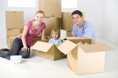 Professional packing team working in a Soho apartment with fragile items and boxes