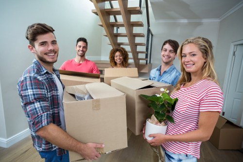 Mover carrying a box with safety gear and planning paperwork
