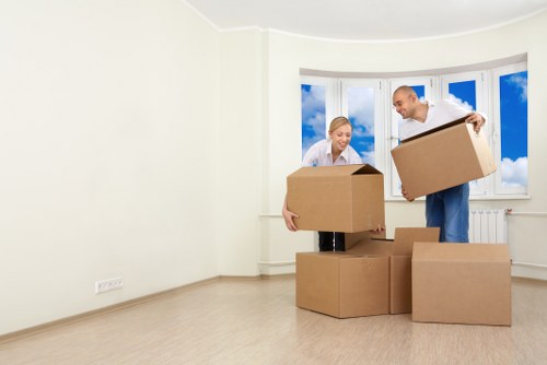 Professional movers handling household items in a Soho apartment building