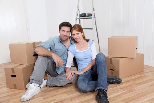 Removal helpers managing stairs in a Soho flat building