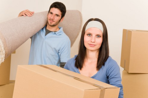 Professional Soho moving team packing fragile items with care