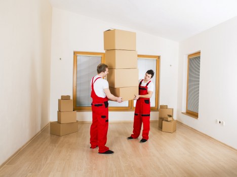 Commercial movers handling office furniture and boxes for a Soho business
